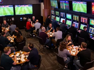Tỷ Lệ Bóng Đá displayed on screens as enthusiastic bettors engage in sports betting